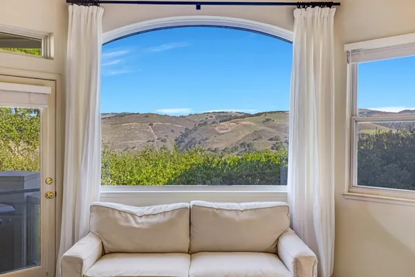 a view of a balcony with furniture and a window