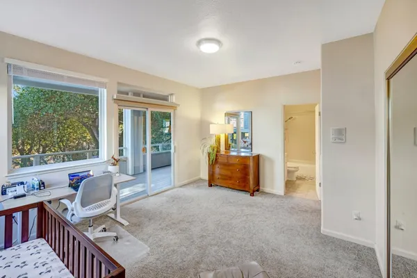 a living room with furniture and large windows