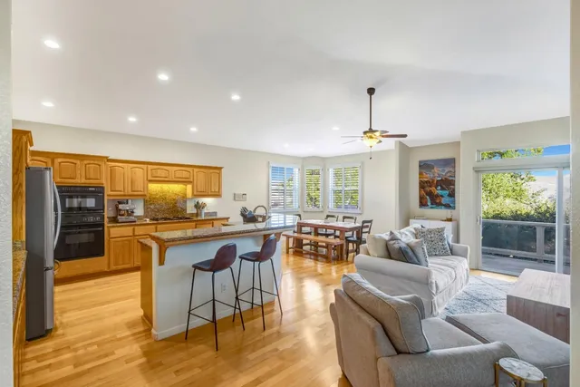 a living room with fireplace furniture and a wooden floor