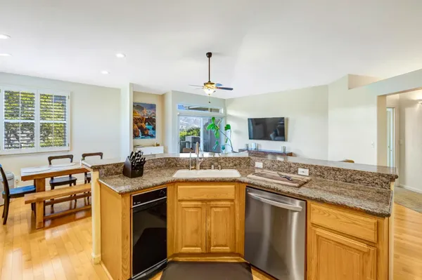 a kitchen with stainless steel appliances granite countertop a sink stove and cabinets