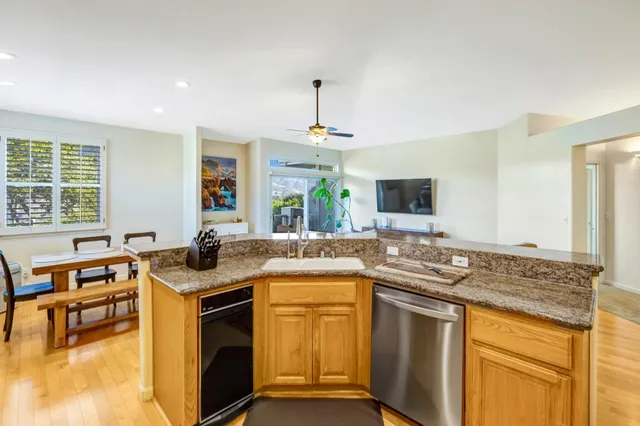 a kitchen with stainless steel appliances granite countertop a sink stove and cabinets