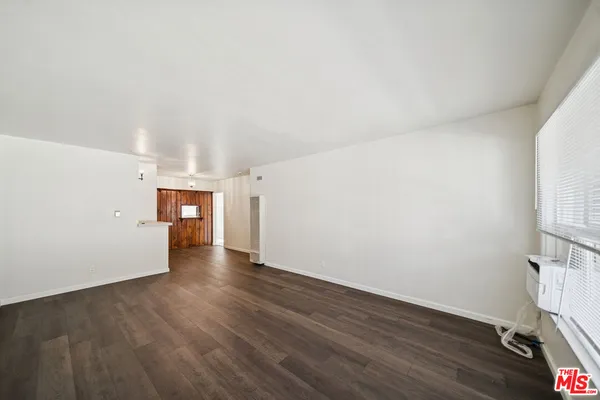 a view of a room with wooden floor and staircase