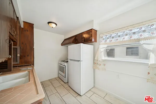 a bathroom with a sink and a refrigerator