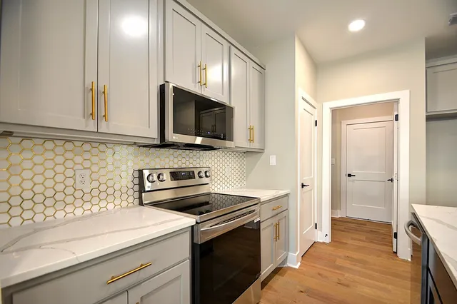 a kitchen with a sink and a stove top oven