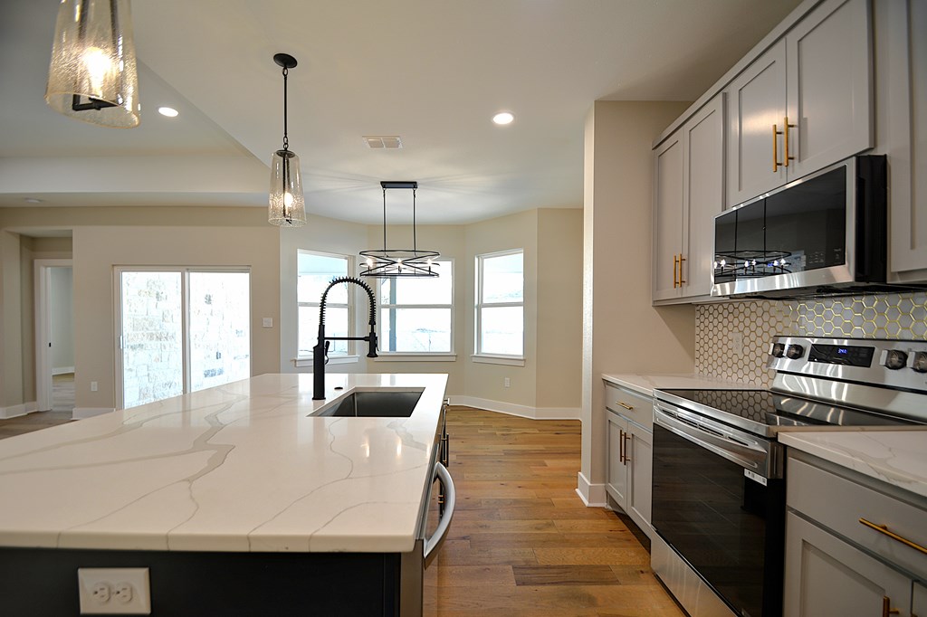 1806 Chateau Kerrville, TX 78028 - Photo 13 of 44 a kitchen with kitchen island a sink appliances and cabinets