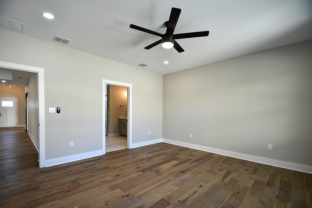 1806 Chateau Kerrville, TX 78028 - Photo 17 of 44 an empty room with wooden floor and a ceiling fan