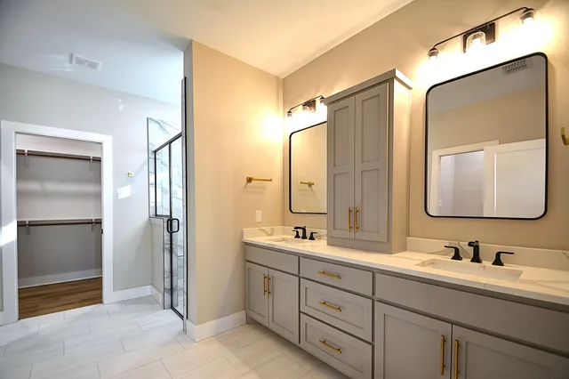 a bathroom with a double vanity sink mirror and double