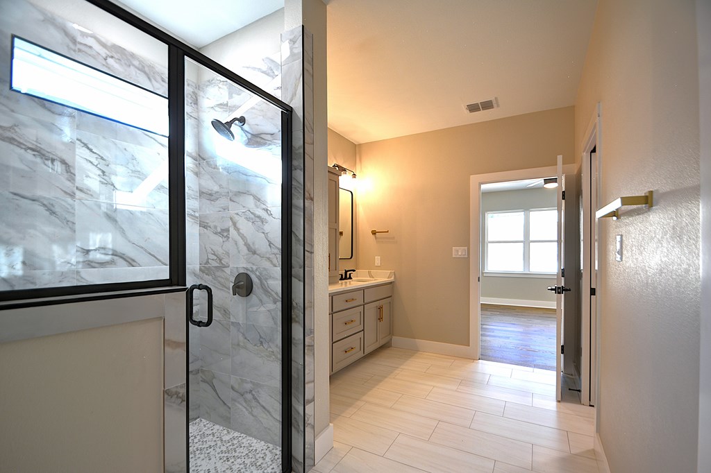 1806 Chateau Kerrville, TX 78028 - Photo 22 of 44 a bathroom with a glass shower door and a bathtub