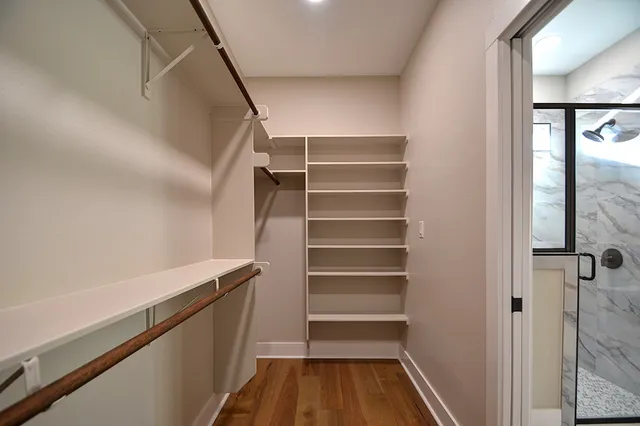 a view of walk in closet with empty racks