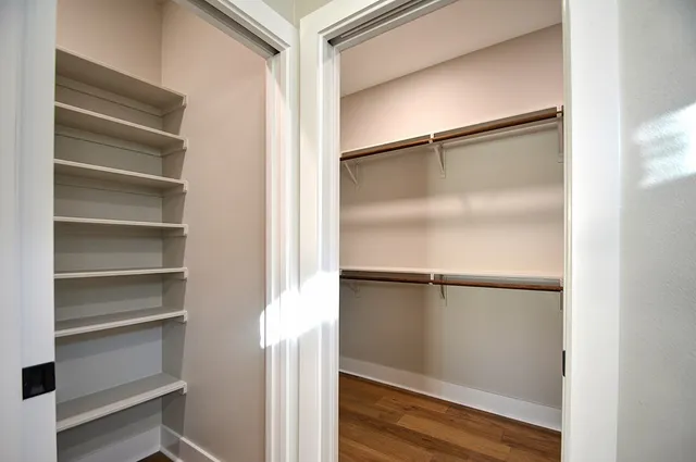 a view of walk in closet with empty racks