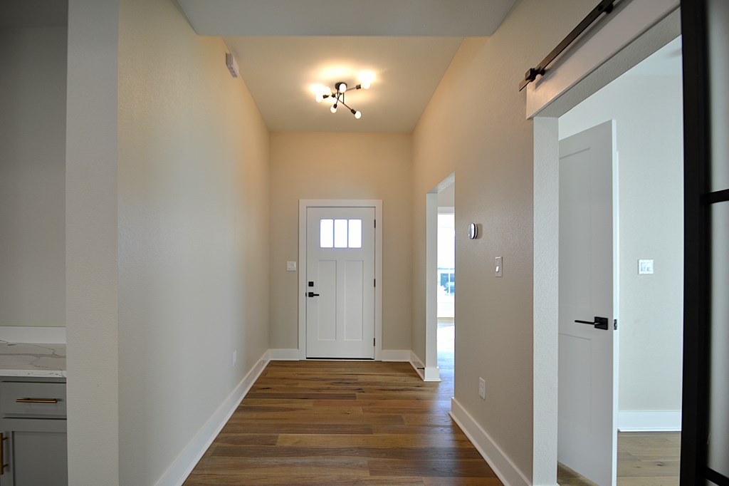 1806 Chateau Kerrville, TX 78028 - Photo 26 of 44 a view of a hallway with wooden floor and a large mirror
