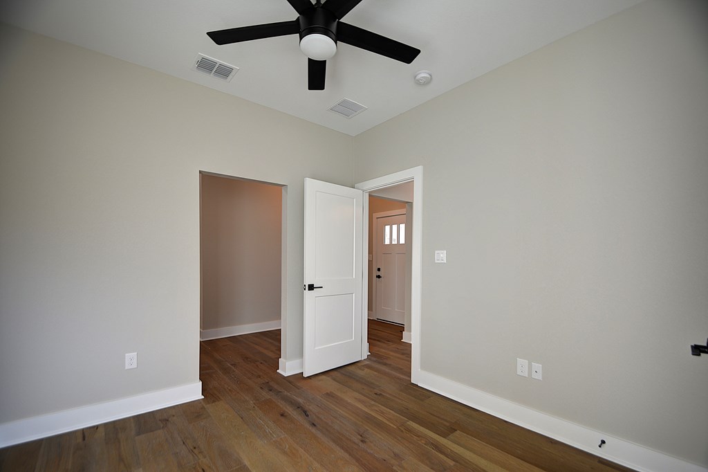 1806 Chateau Kerrville, TX 78028 - Photo 30 of 44 an empty room with wooden floor and ceiling fan
