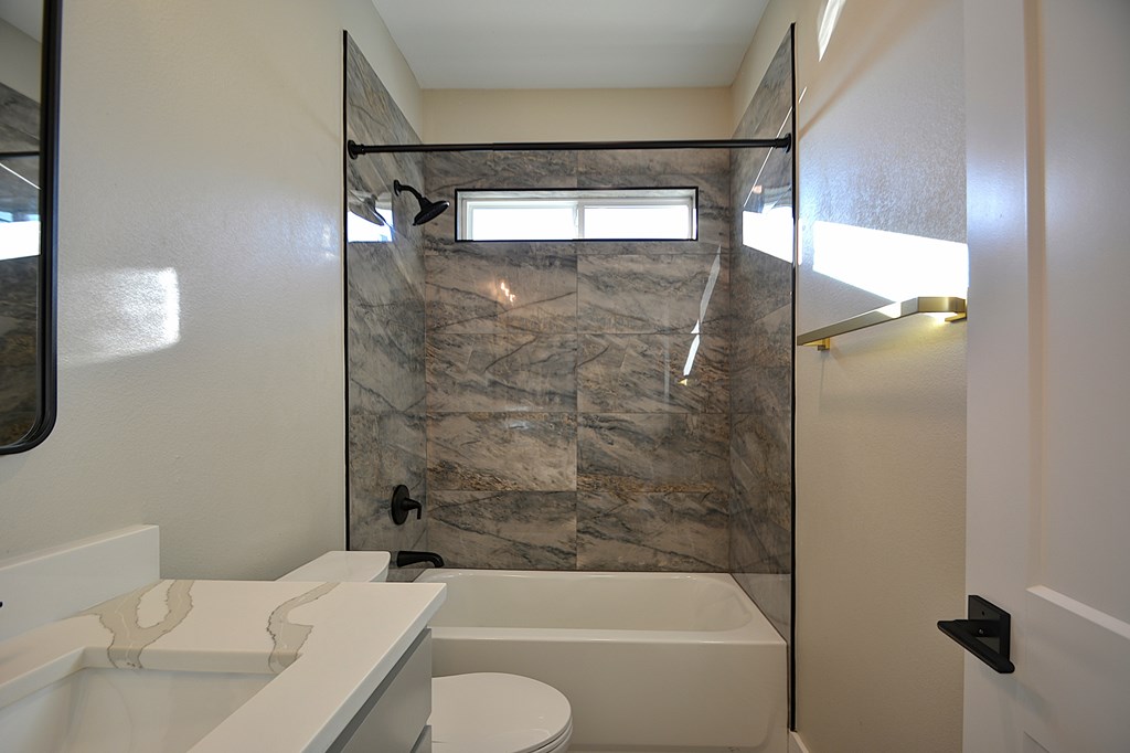 1806 Chateau Kerrville, TX 78028 - Photo 32 of 44 a bathroom with a granite countertop bathtub shower sink vanity and toilet