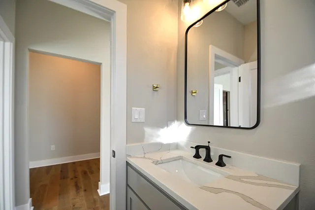 a bathroom with a sink and a mirror