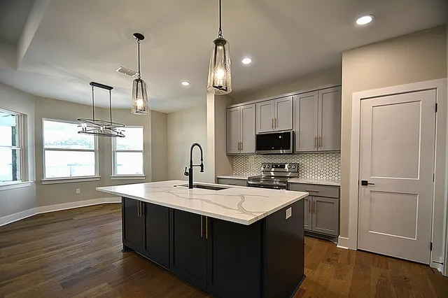 a kitchen with sink refrigerator and microwave