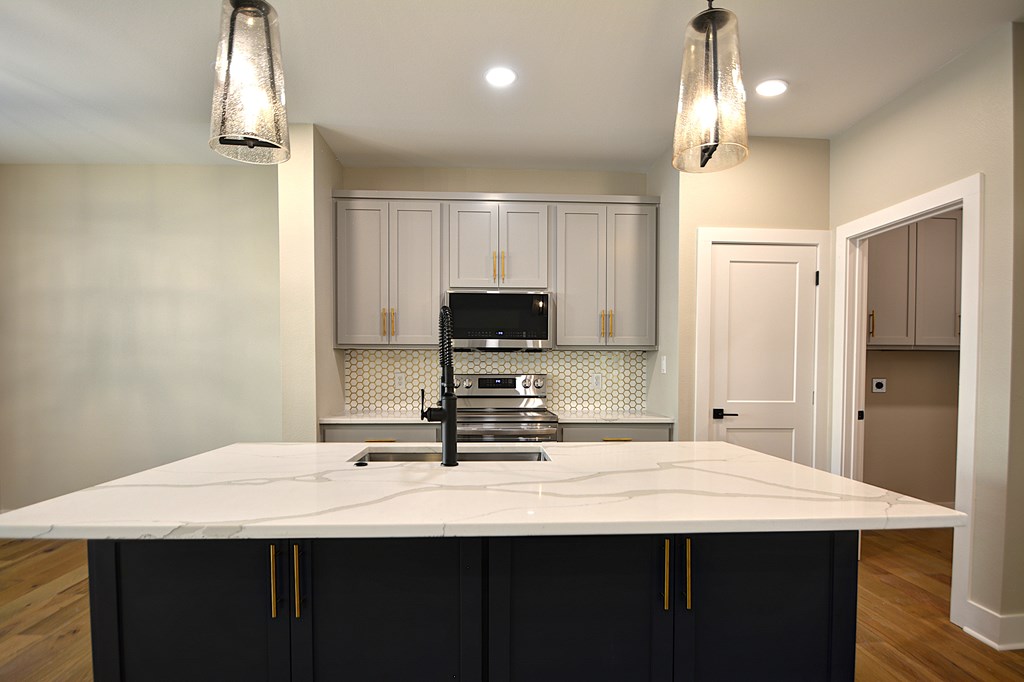 1806 Chateau Kerrville, TX 78028 - Photo 8 of 44 a kitchen with kitchen island a sink stainless steel appliances and cabinets
