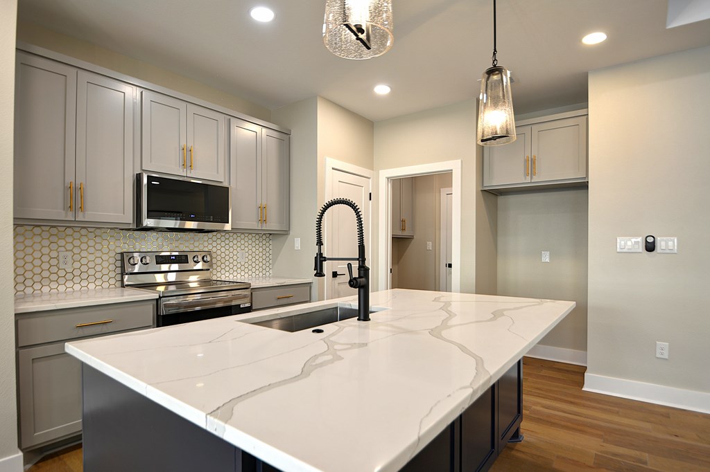 1806 Chateau Kerrville, TX 78028 - Photo 9 of 44 a kitchen with stainless steel appliances a stove microwave and sink