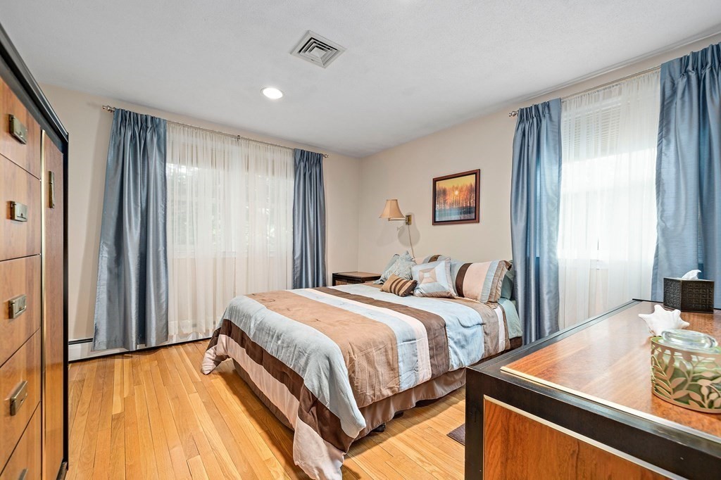 4 Kings Road Canton, MA 02021 - Photo 16 of 33 a bedroom with a bed and wooden floor