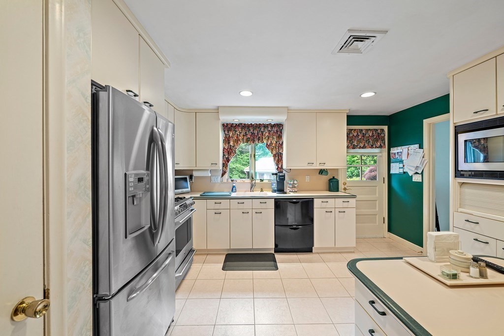 4 Kings Road Canton, MA 02021 - Photo 4 of 33 a kitchen with stainless steel appliances granite countertop a refrigerator sink and stove
