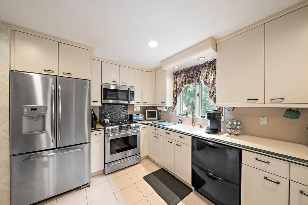 4 Kings Road Canton, MA 02021 - Photo 5 of 33 a kitchen with stainless steel appliances a refrigerator sink and microwave