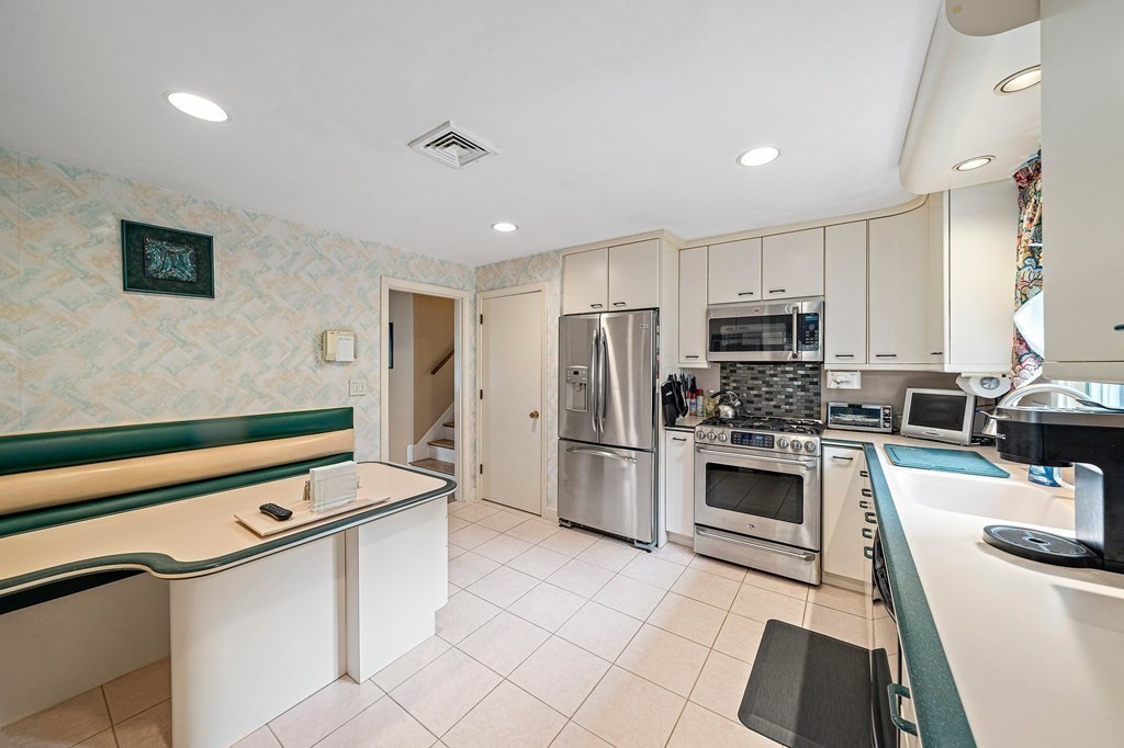 4 Kings Road Canton, MA 02021 - Photo 7 of 33 a kitchen with kitchen island a stove a sink and a refrigerator