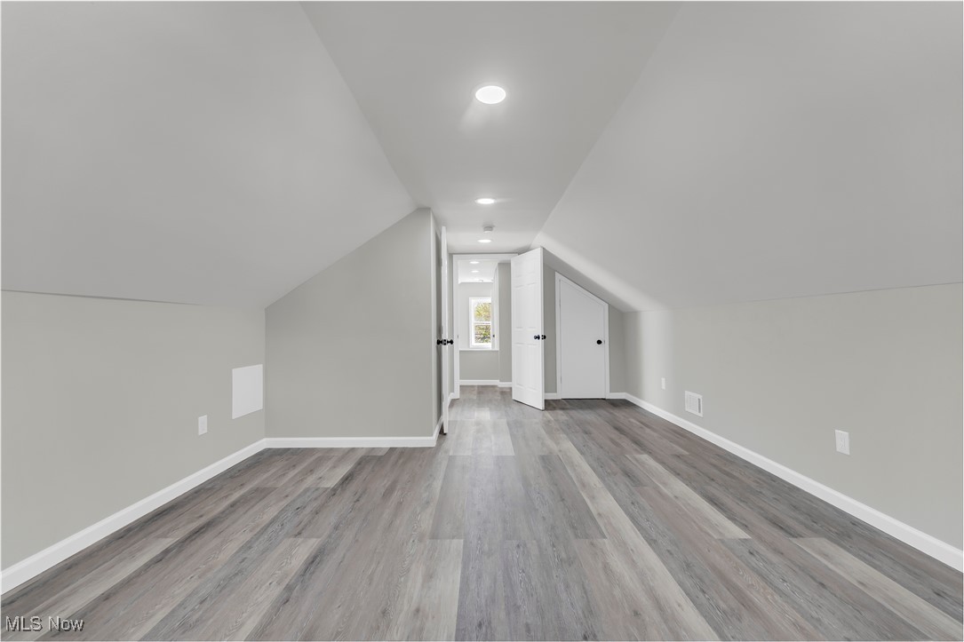4124 Bayard Road Cleveland, OH 44121 - Photo 25 of 35 Additional living space featuring lofted ceiling and light wood-style floors
