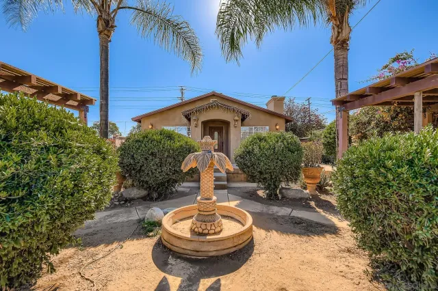 a front view of a house with a yard balcony and outdoor seating