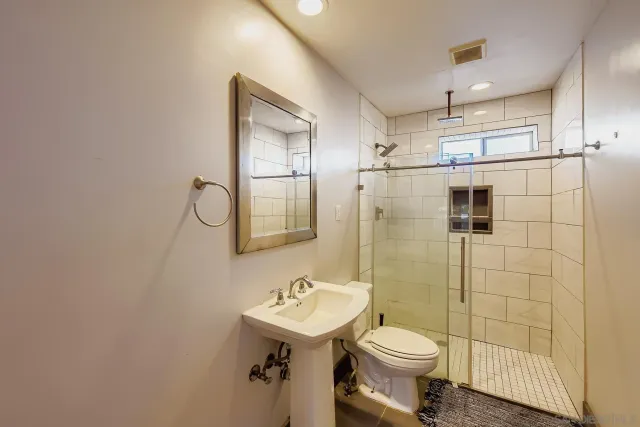 a bathroom with a sink toilet and shower
