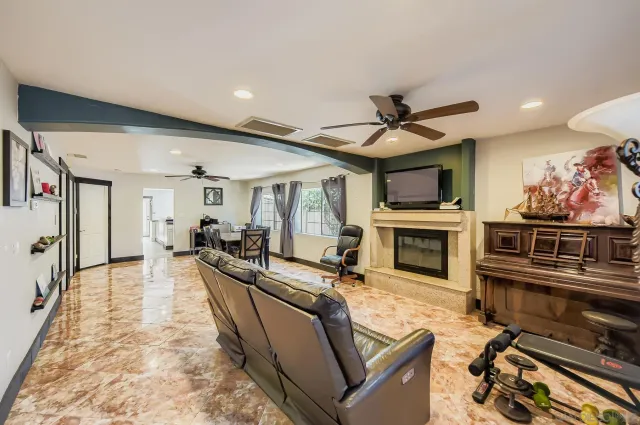 a living room with fireplace furniture and a flat screen tv