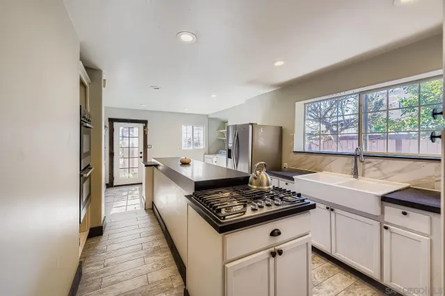 a kitchen with a stove and a refrigerator