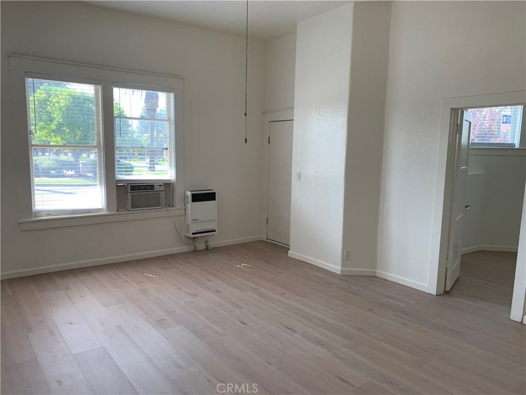 403 Cajon Street, Unit 5 Redlands, CA 92373 - Photo 4 of 16 an empty room with wooden floor and windows