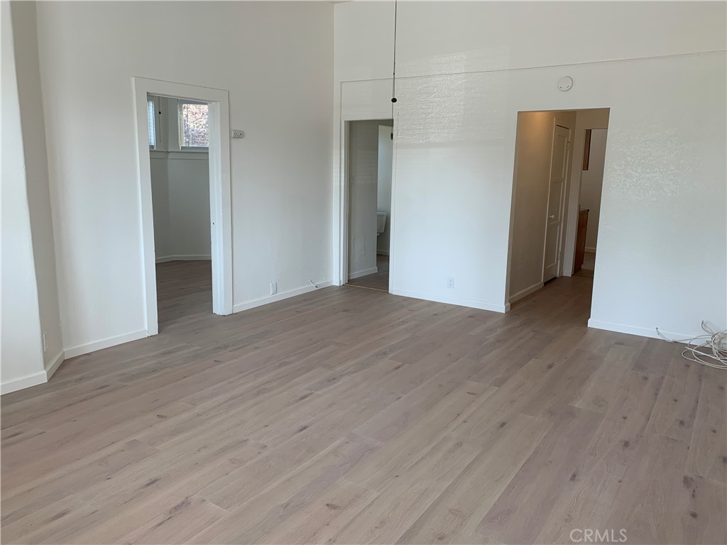 403 Cajon Street, Unit 5 Redlands, CA 92373 - Photo 5 of 16 an empty room with wooden floor and closet