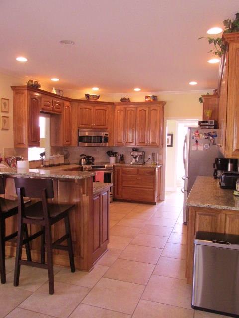 136 Barbara Spears Road Morrison, TN 37357 - Photo 10 of 26 Kitchen has a bar area and comes with a convection oven/microwave, stove/range, dishwasher, and fridge.