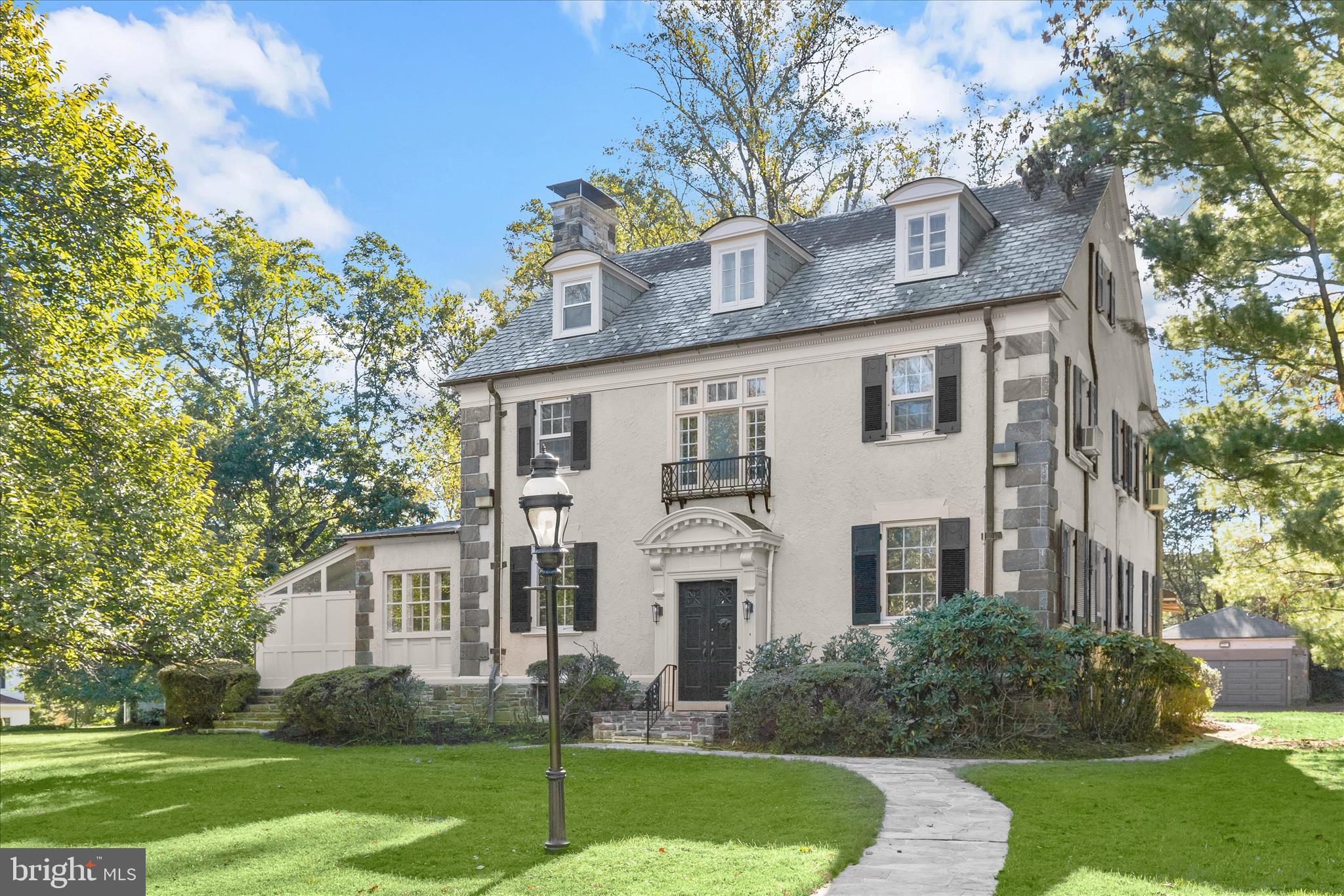 2209 Ken Oak Road Baltimore, MD 21209 - Photo 3 of 102 a view of a white house next to a yard with big trees