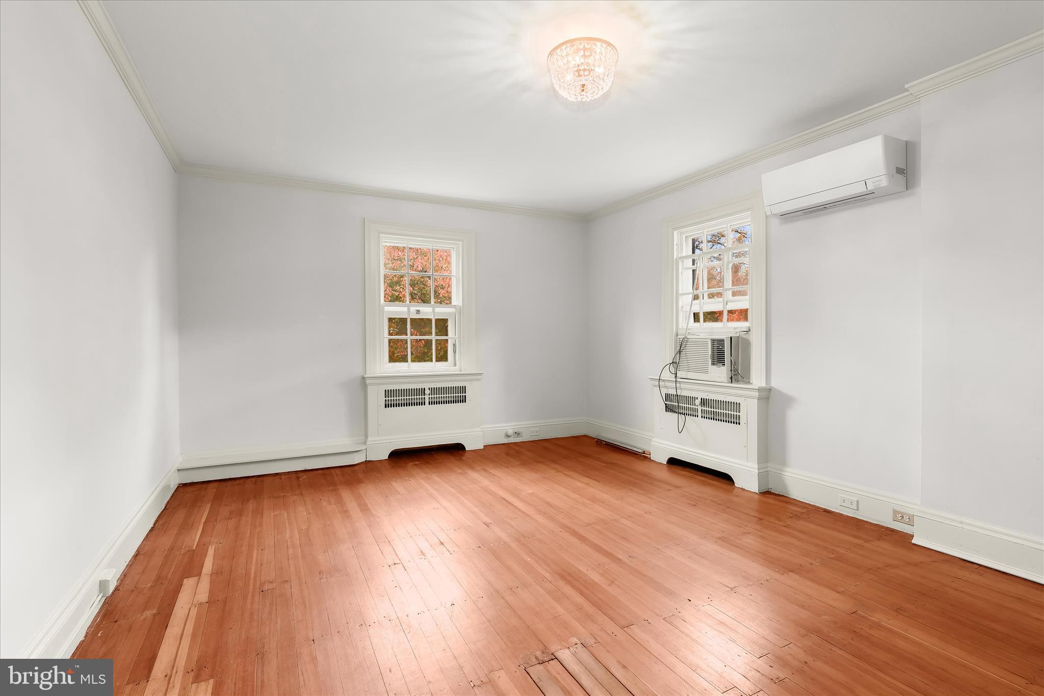2209 Ken Oak Road Baltimore, MD 21209 - Photo 43 of 102 an empty room with wooden floor and windows