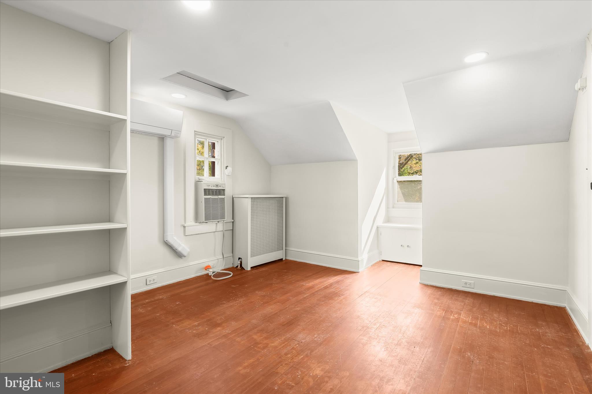 2209 Ken Oak Road Baltimore, MD 21209 - Photo 63 of 102 a view of empty room with wooden floor and window
