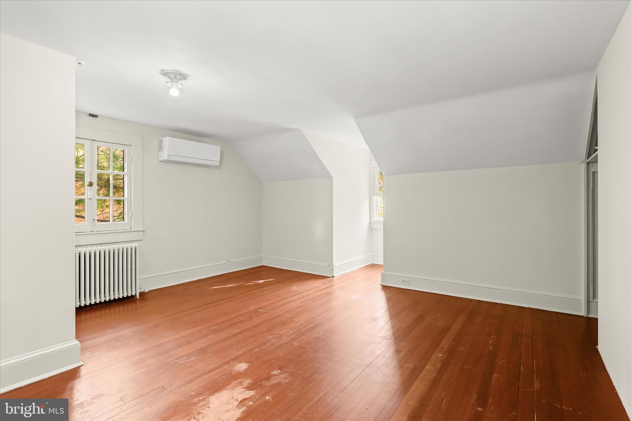 2209 Ken Oak Road Baltimore, MD 21209 - Photo 64 of 102 an empty room with wooden floor and windows