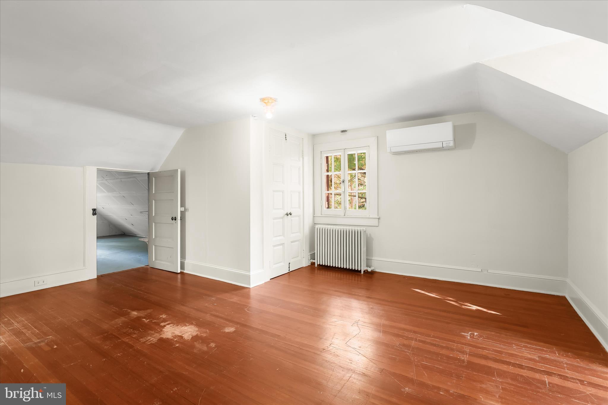 2209 Ken Oak Road Baltimore, MD 21209 - Photo 65 of 102 an empty room with wooden floor and windows