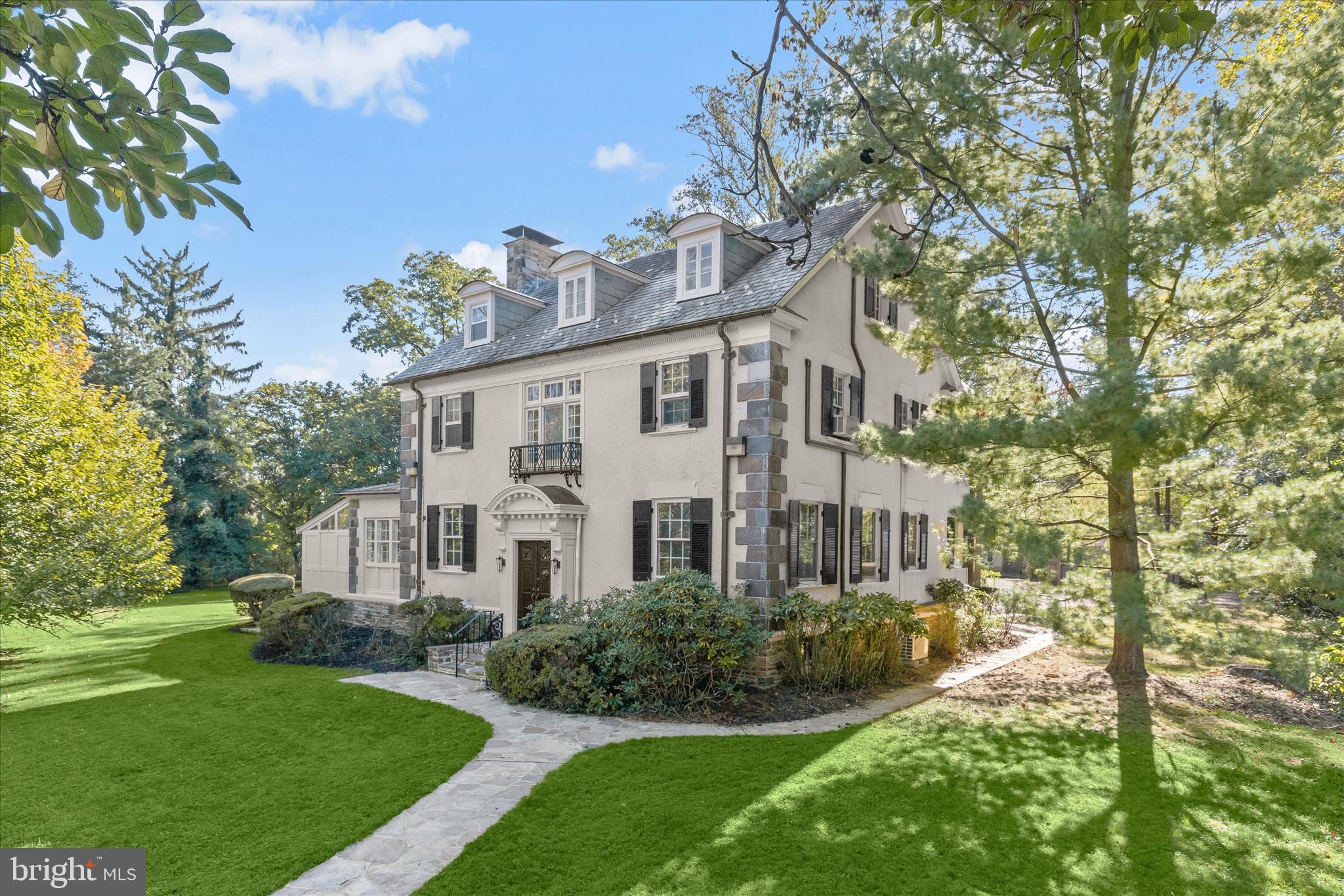 2209 Ken Oak Road Baltimore, MD 21209 - Photo 84 of 102 a view of a white house next to a yard with big trees