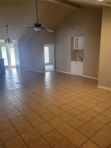 an empty room with windows and glass door