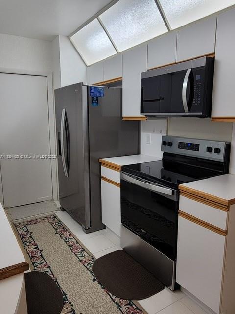1000 West Island Boulevard, Unit 1511 Aventura, FL 33160 - Photo 11 of 41 a kitchen with stainless steel appliances granite countertop a refrigerator and a stove top oven