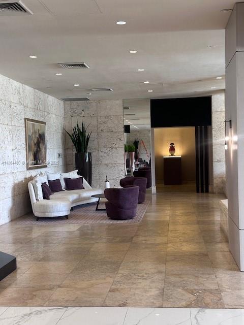 1000 West Island Boulevard, Unit 1511 Aventura, FL 33160 - Photo 27 of 41 a living room with furniture and a fireplace