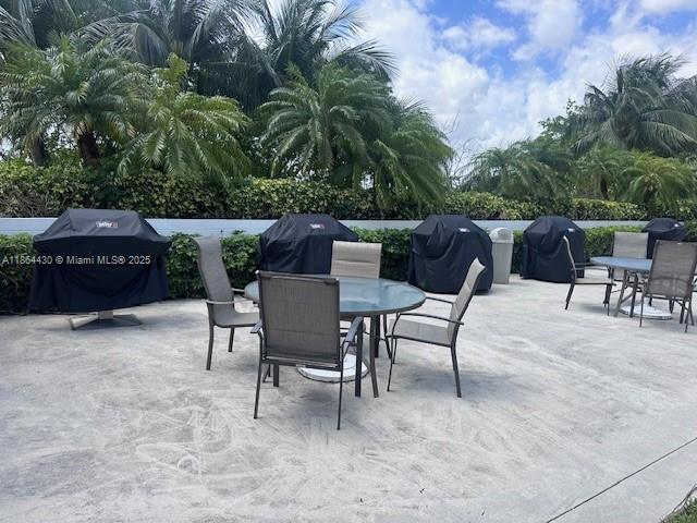1000 West Island Boulevard, Unit 1511 Aventura, FL 33160 - Photo 35 of 41 a view of backyard with seating area and trees