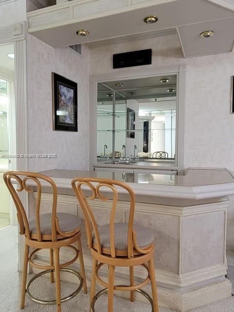 1000 West Island Boulevard, Unit 1511 Aventura, FL 33160 - Photo 10 of 41 a dining table chair sitting in a kitchen next to a window