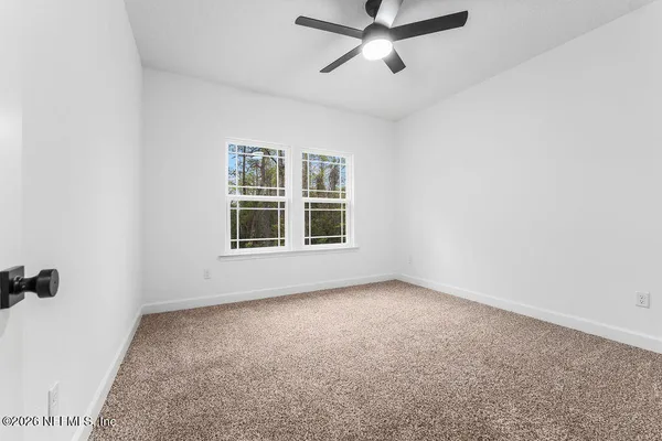 an empty room with a empty space and windows