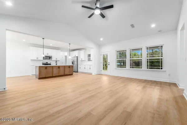 a view of a kitchen with a sink and a window