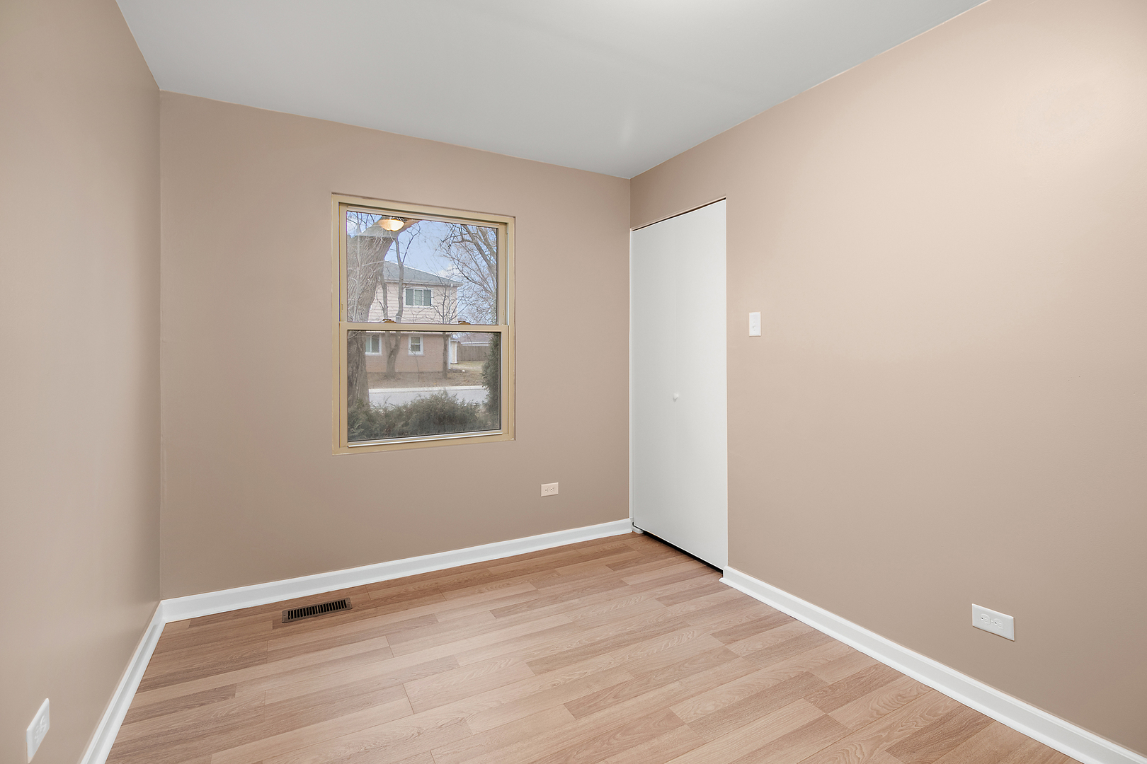 310 Nassau Street Park Forest, IL 60466 - Photo 17 of 19 a view of an empty room with wooden floor and a window