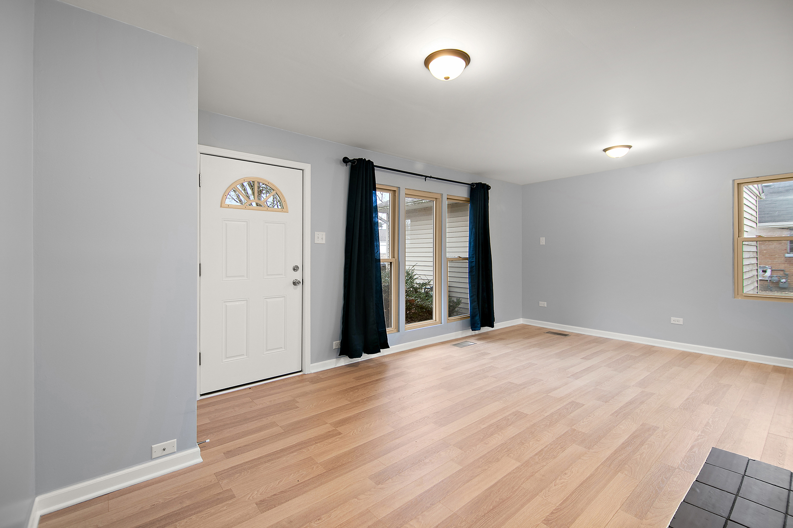 310 Nassau Street Park Forest, IL 60466 - Photo 3 of 19 a view of an empty room with wooden floor and a window
