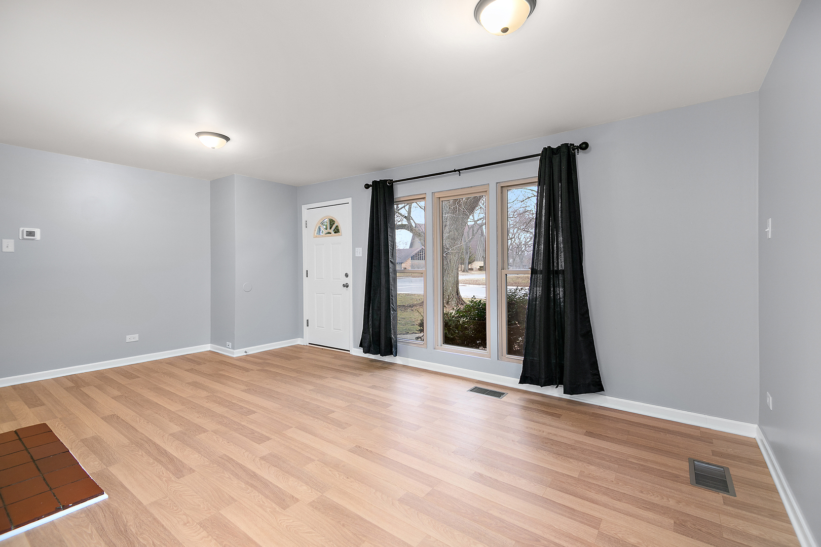 310 Nassau Street Park Forest, IL 60466 - Photo 4 of 19 a view of an empty room with wooden floor and a window