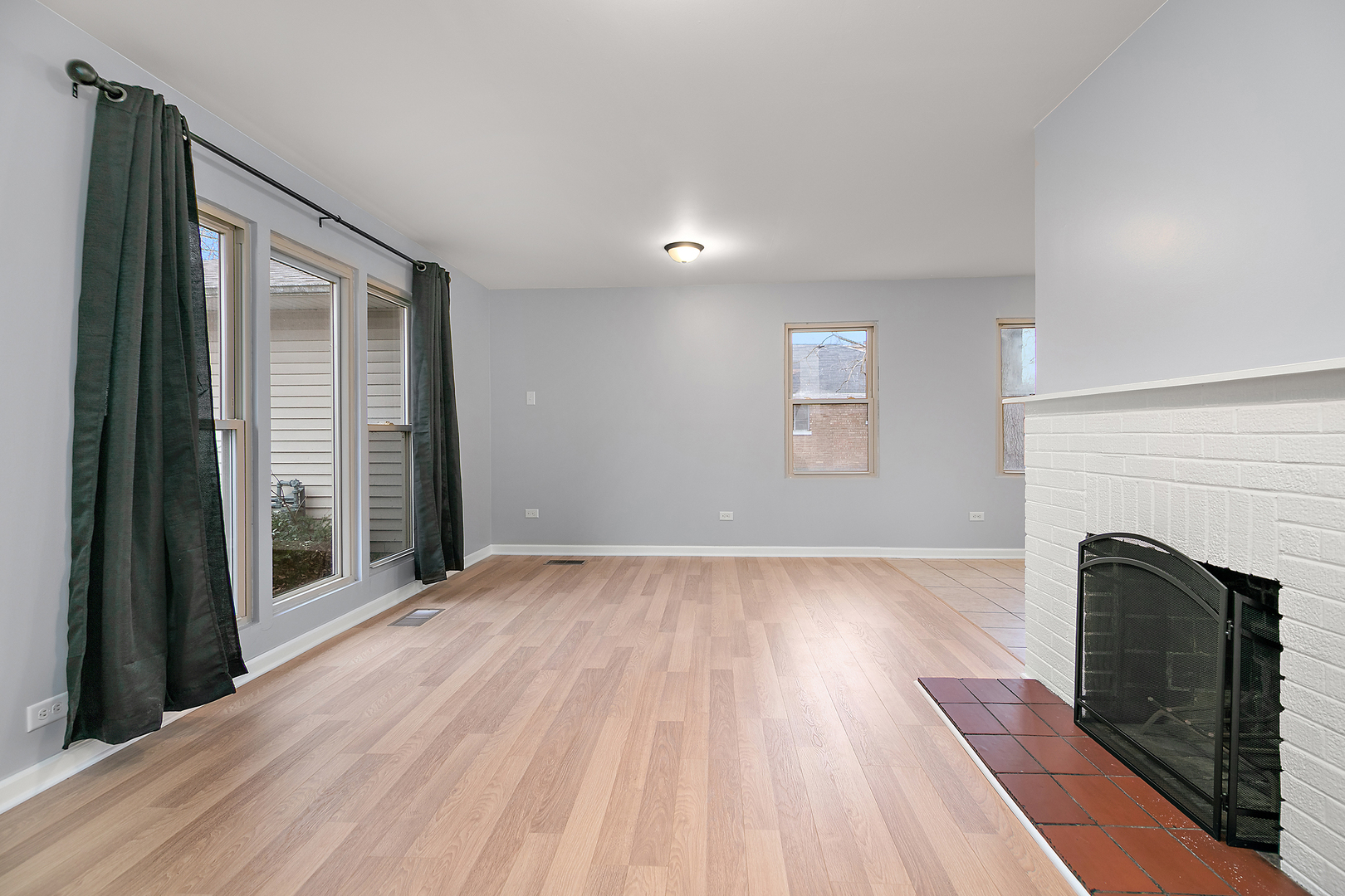 310 Nassau Street Park Forest, IL 60466 - Photo 6 of 19 an empty room with wooden floor fireplace and windows